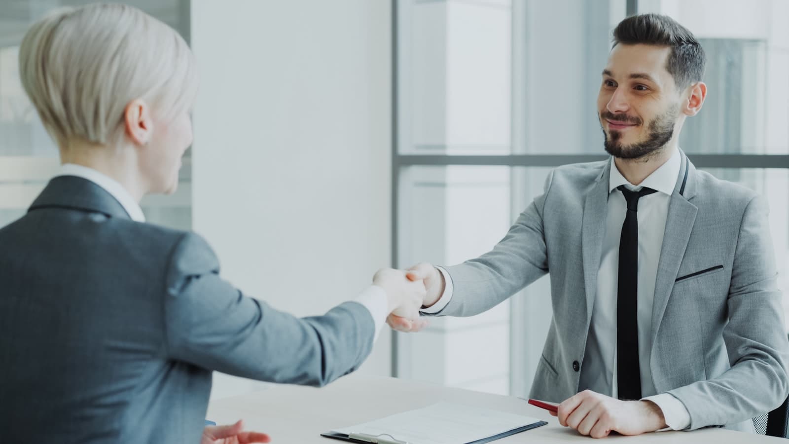 Two partners shaking hands after a productive strategy meeting